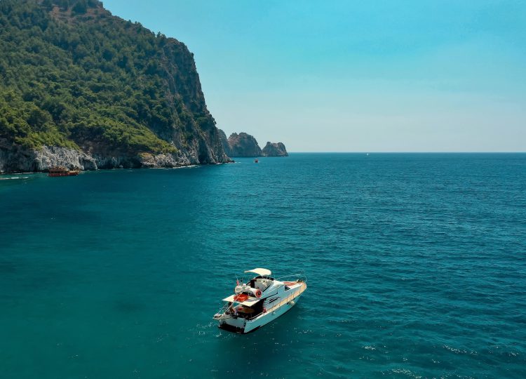 Sailboat in the sea in the evening sunlight over beautiful big mountains background, luxury summer adventure, active vacation in Mediterranean sea, Turkey